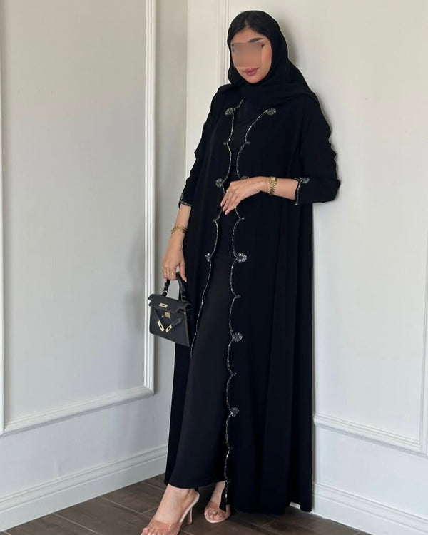 Model wearing a full-length black Rahath abaya